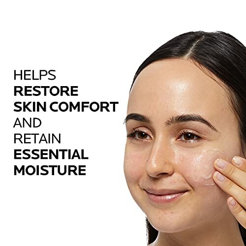 Woman applying skincare product for moisture restoration.